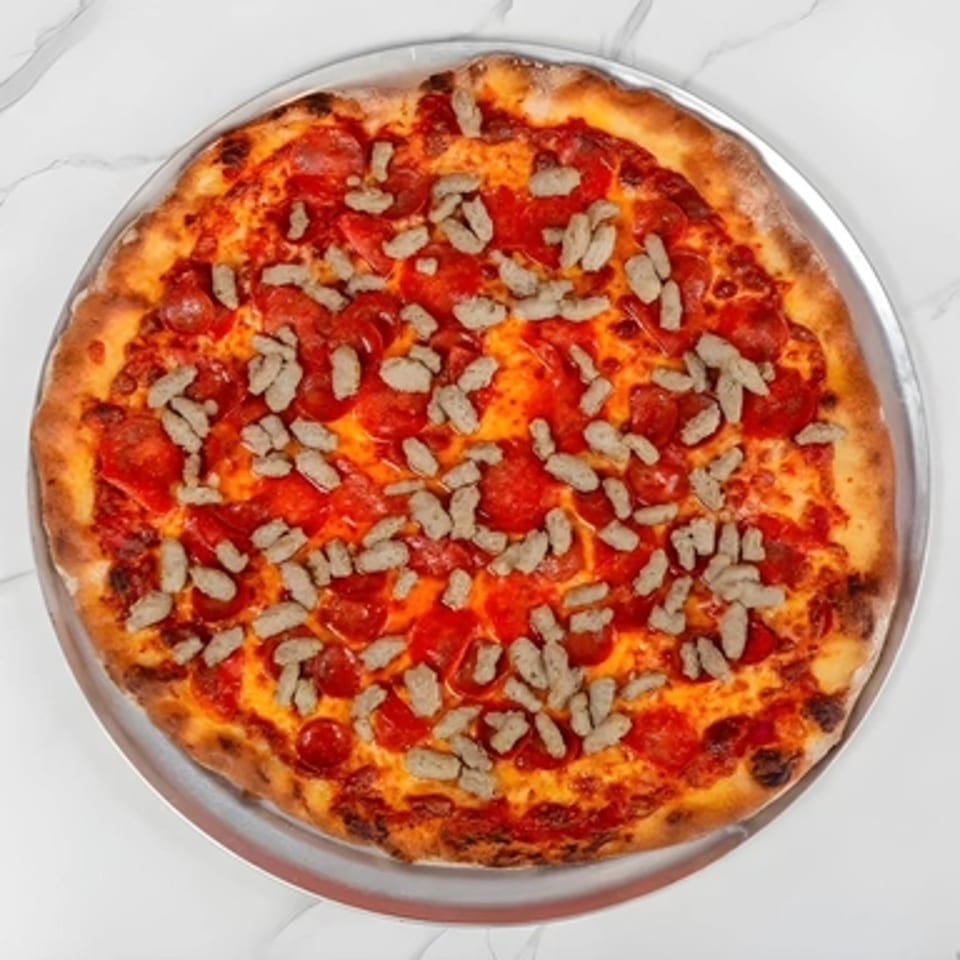 Big Oven Pizza's pepperoni and sausage pizza on a metal tray, ready for catering.