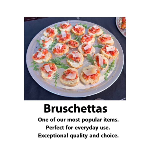 A catering tray of bruschettas with diced tomatoes, parmesan, and arugula on a black tablecloth.