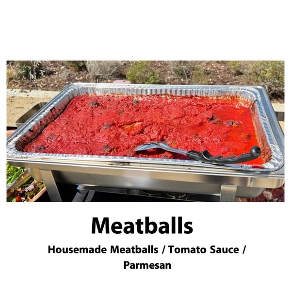 A large catering pan of Big Oven Pizza's meatballs in rich red tomato sauce with a serving spoon.