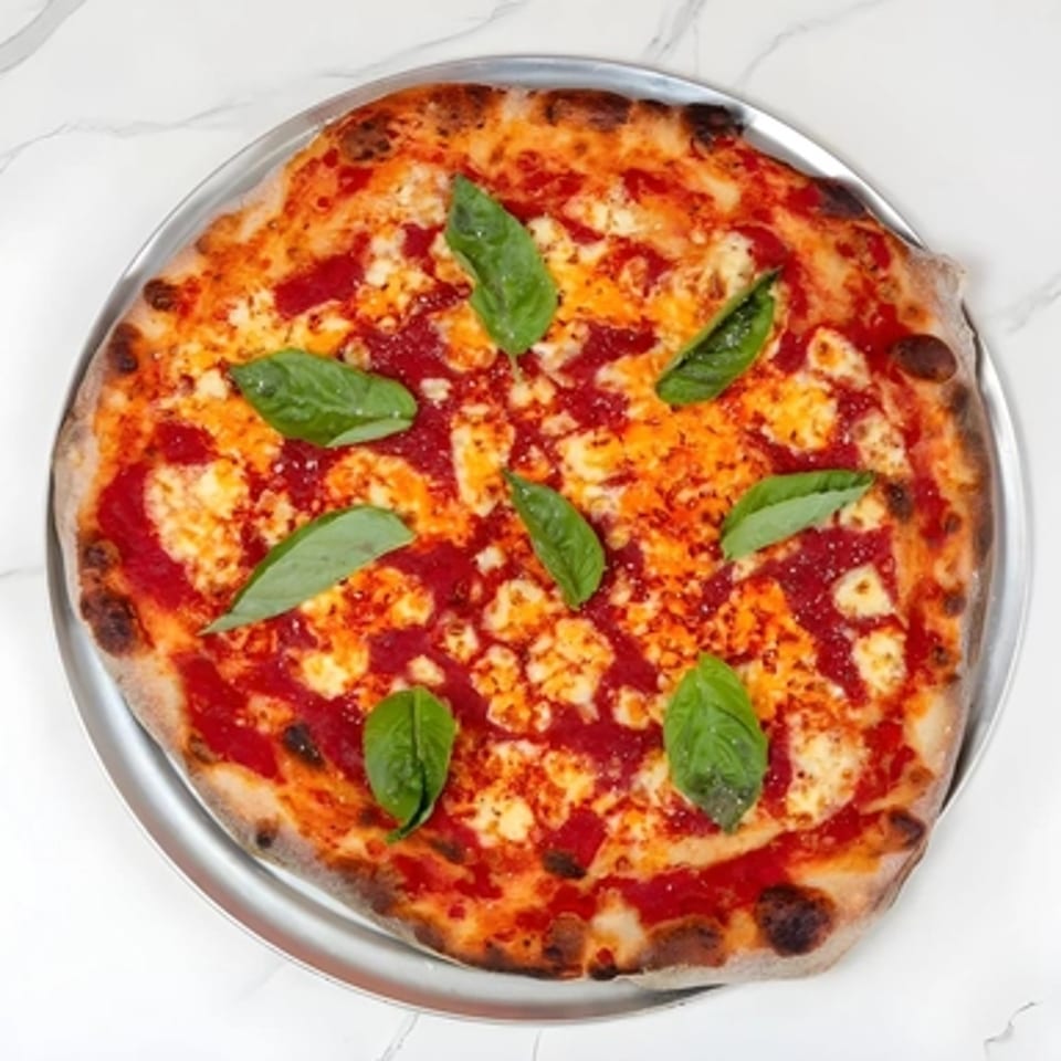 Big Oven Pizza Mobile Truck's catering Margherita pizza with fresh basil on a metal tray.