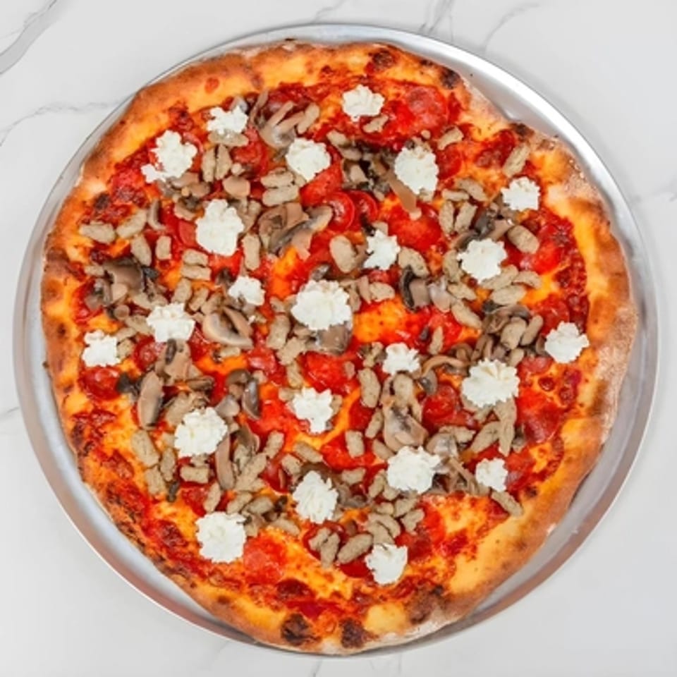 A Big Oven Pizza with pepperoni, mushrooms, and dollops of ricotta cheese on a metal tray.