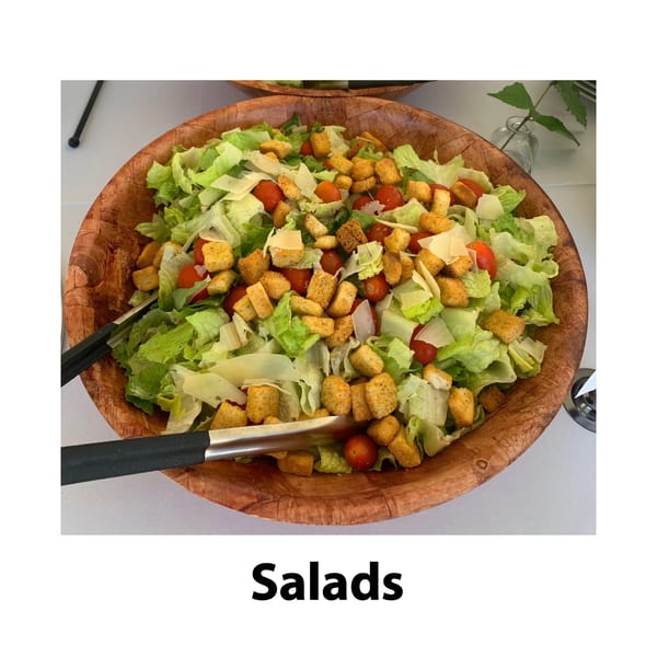 Large wooden bowl of fresh salad with lettuce, cherry tomatoes, croutons, and parmesan cheese.